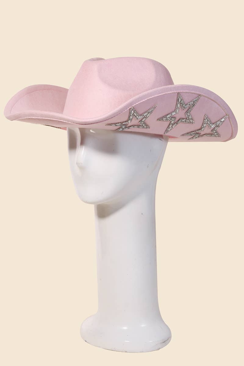 Pink cowboy hat with star designs on a mannequin head against a beige background