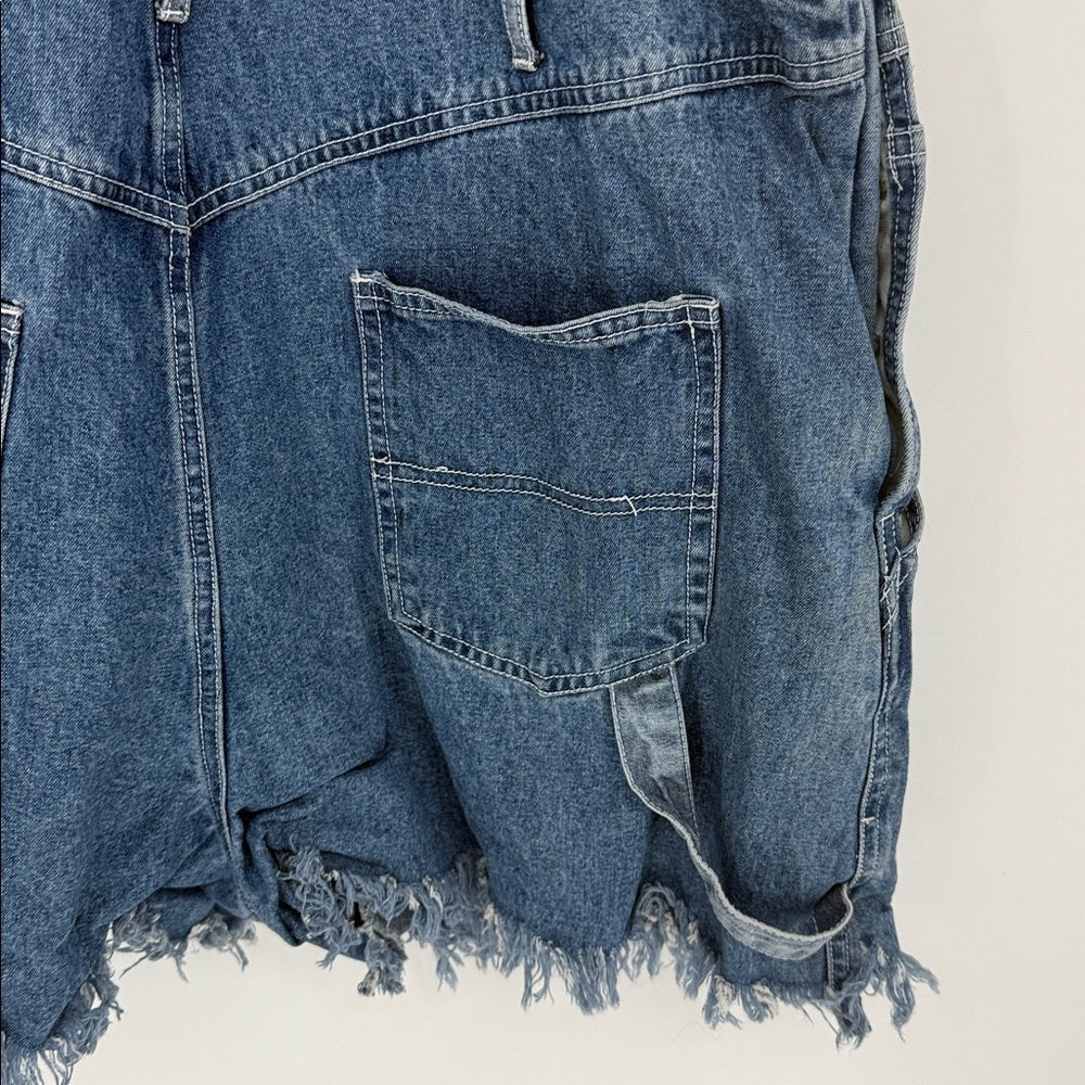 Blue denim shirt with frayed edges on a beige background