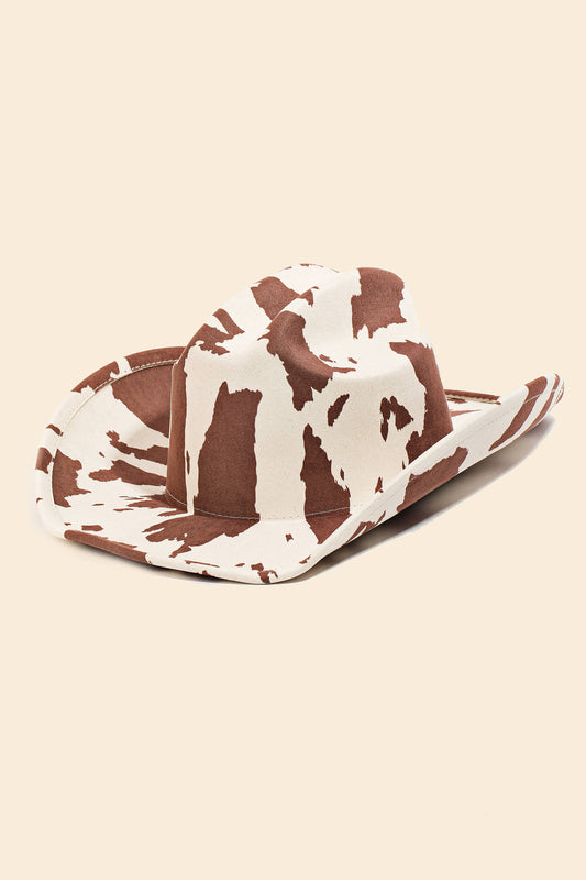 Cow print cowboy hat on a beige background