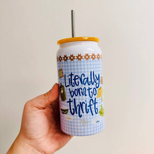 Hand holding a can with 'Literally born to thrift' text against a plain background