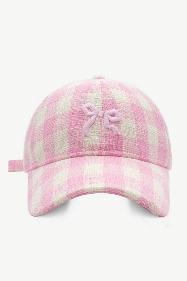 Pink plaid cap with a bow on a white background