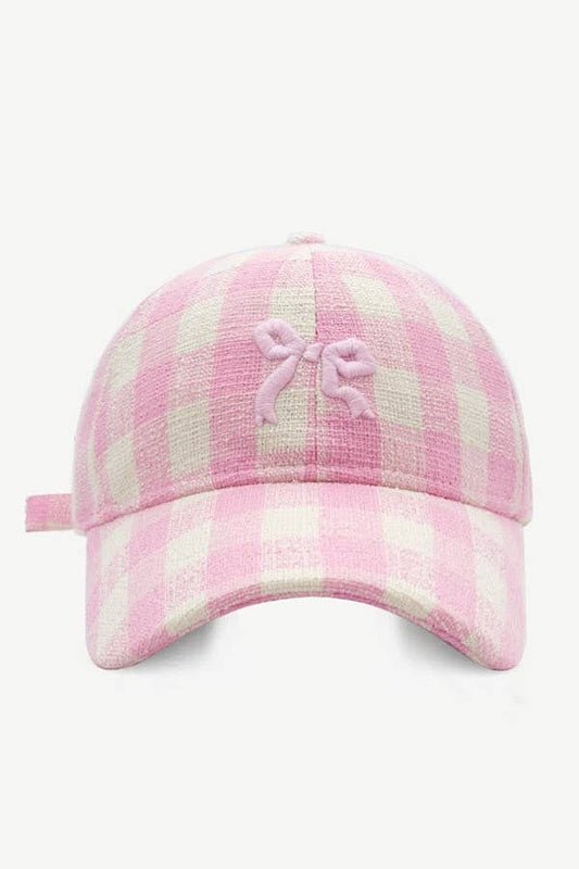Pink plaid cap with a bow on a white background