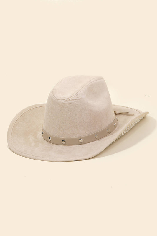 Beige cowboy hat with a band on a beige background