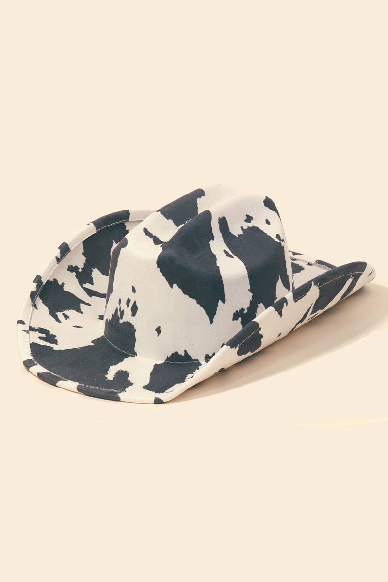 Cowboy hat with black cow print on white background