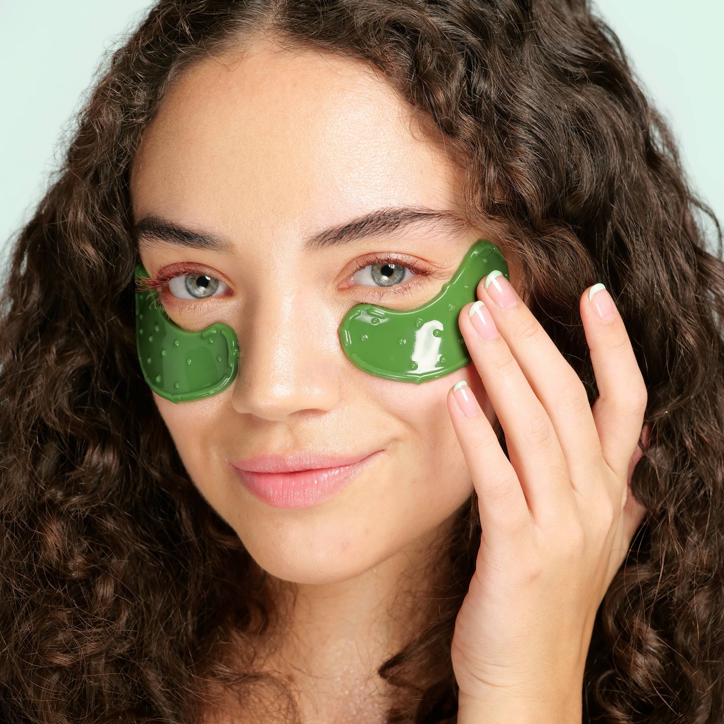 women wearing pickle undereye masks on green background