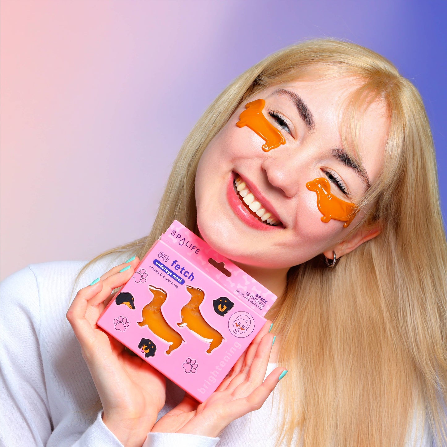 Woman wearing dog-shaped eye patches and holding a pink box with similar design against a gradient background