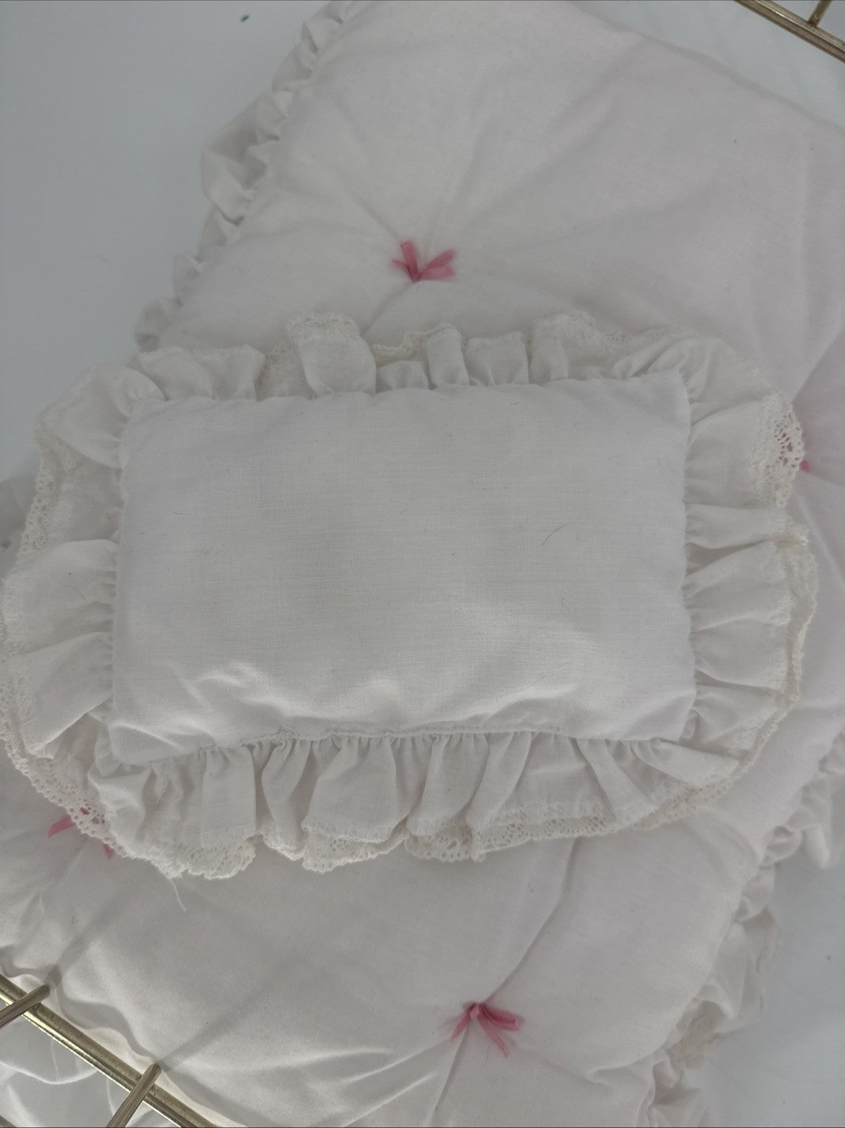 White lace-trimmed pillow on a white background