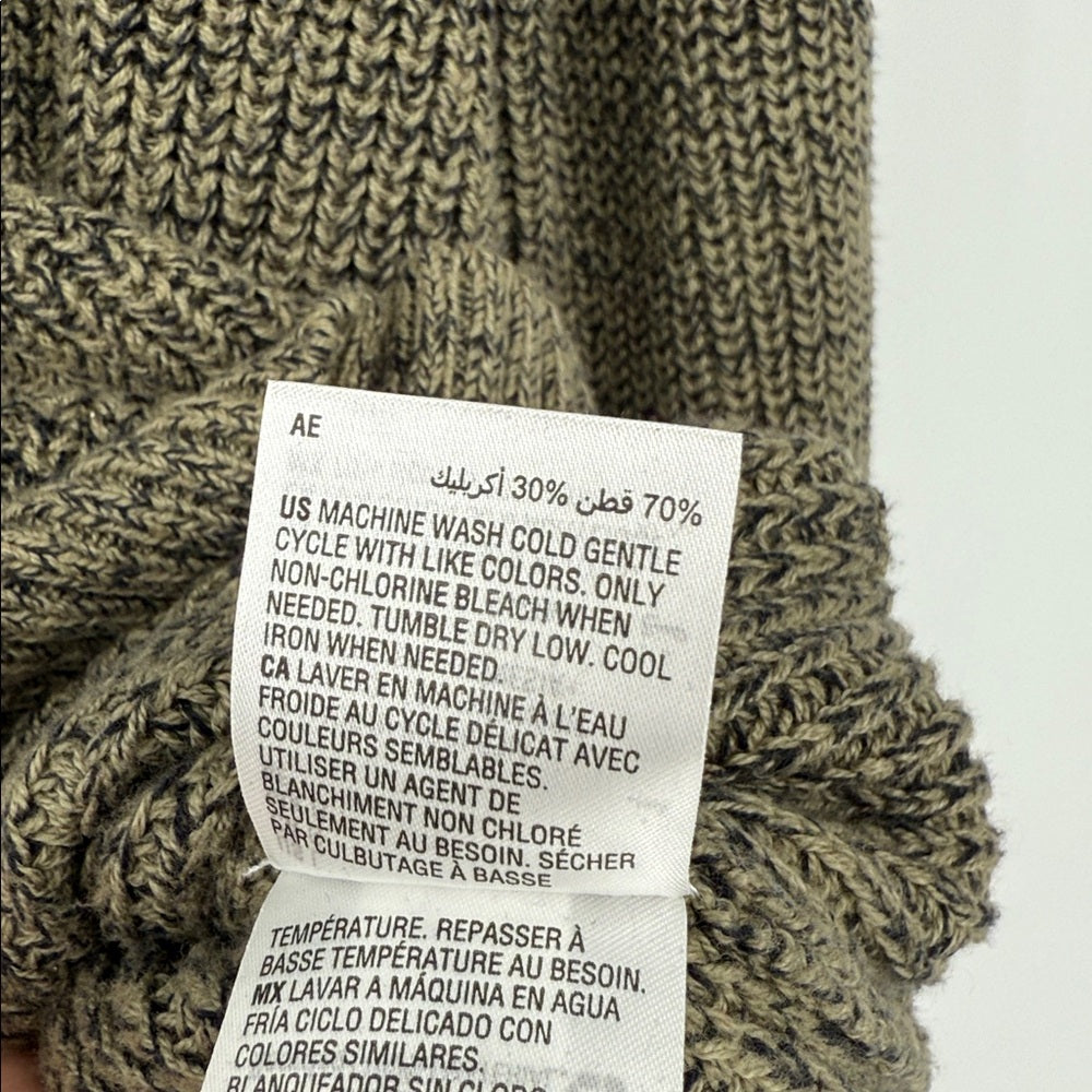 Close-up of a label on a knitted sweater with washing instructions.