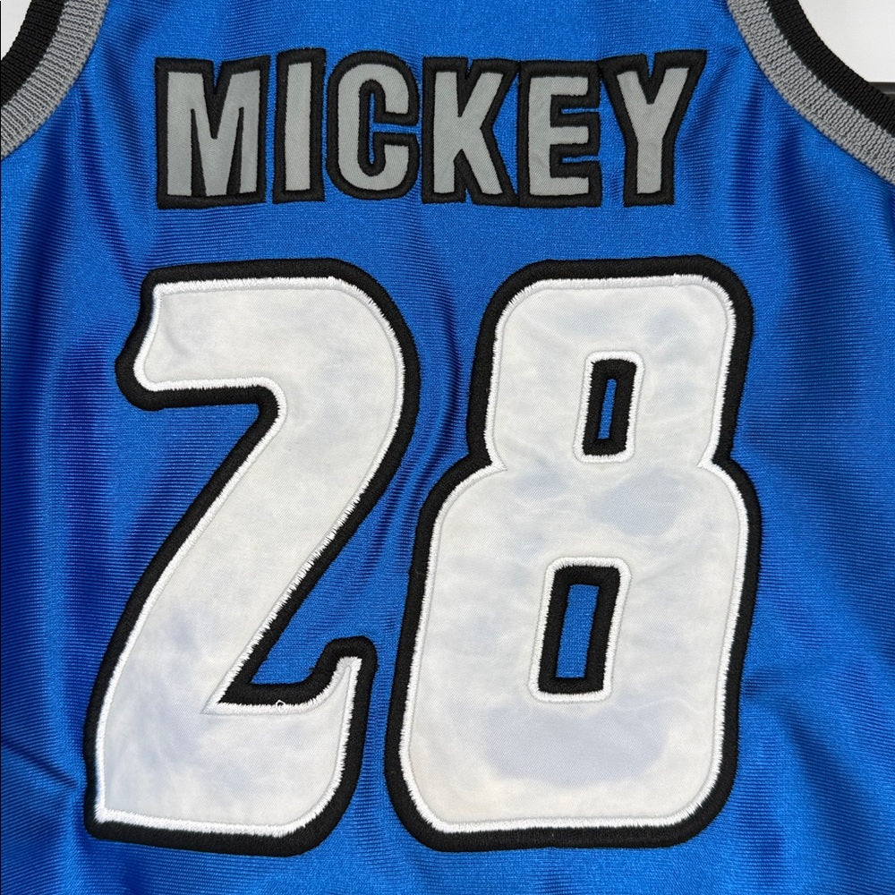 close up Back view of blue Mickey Mouse basketball baby romper with ‘Mickey’ name and number 28 graphic, gray trim, and sleeveless design.