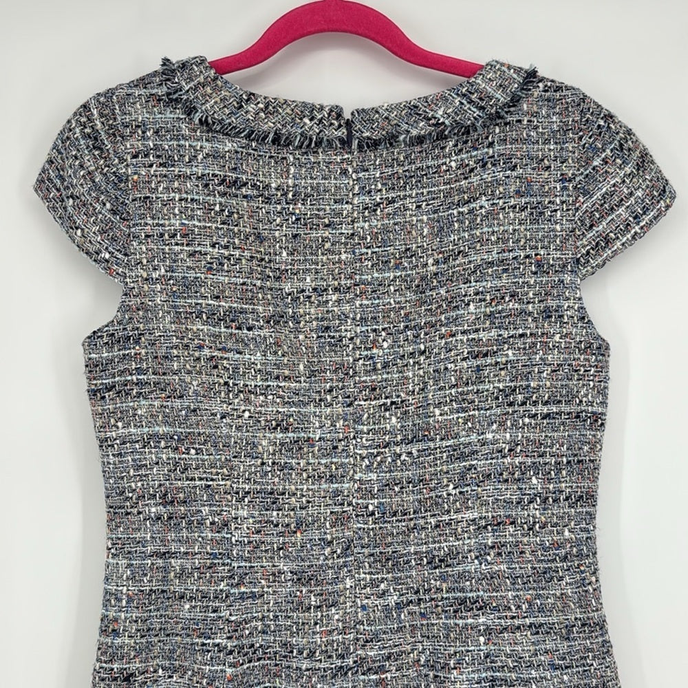 Textured top on a hanger against a white background