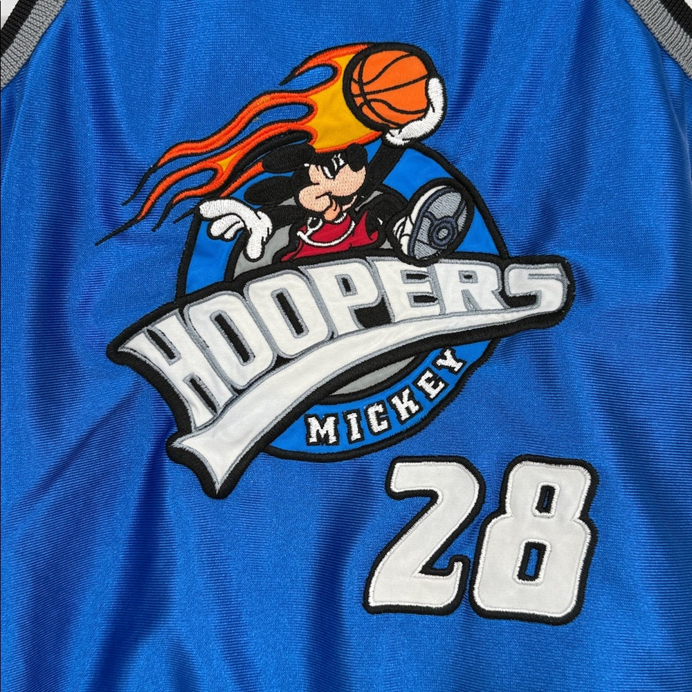 close up Blue baby romper featuring Mickey Mouse ‘Hoopers’ basketball graphic with number 28, gray trim, snap closures, and Walt Disney World Athletics patch on the front.