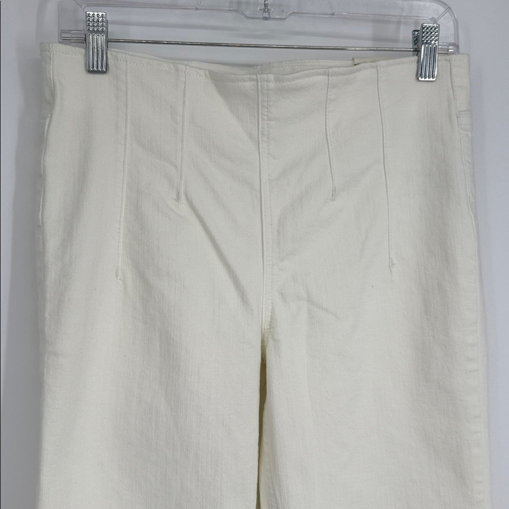 Beige pants on a hanger against a white background