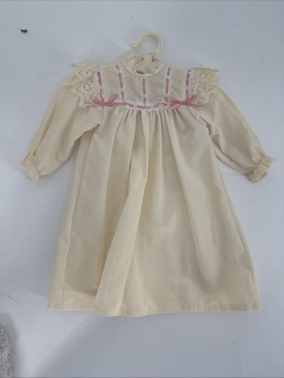 Beige dress with pink accents on a white background