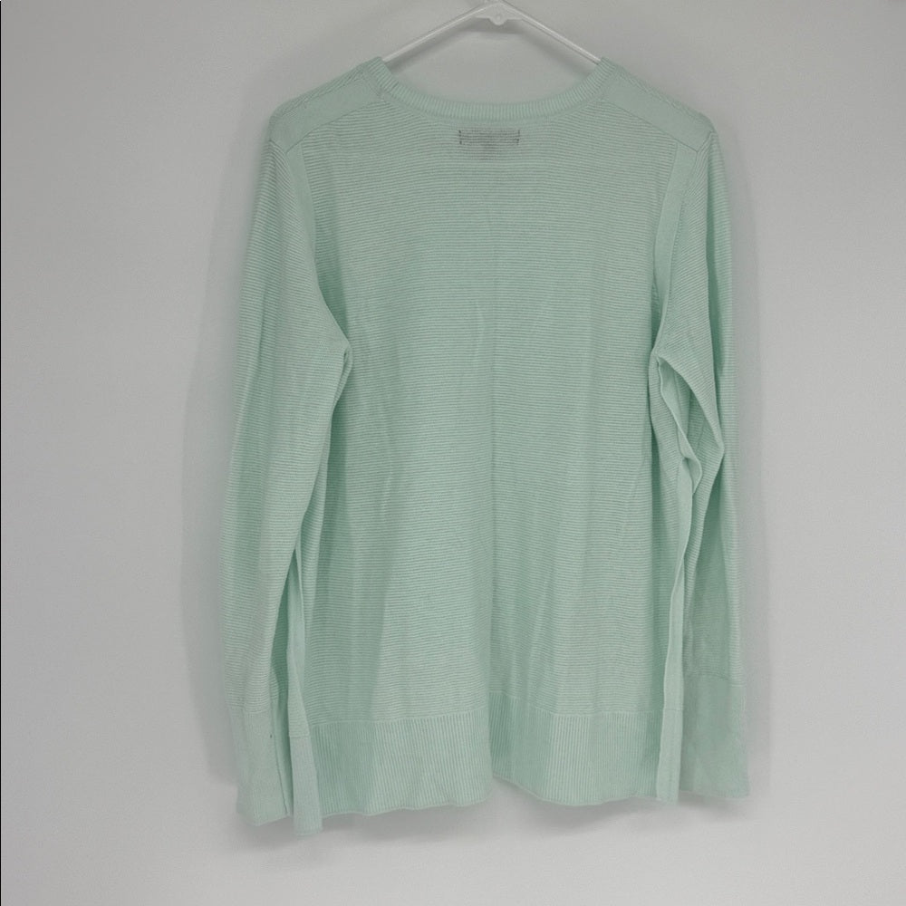 Light green long-sleeve shirt on a hanger against a white background
