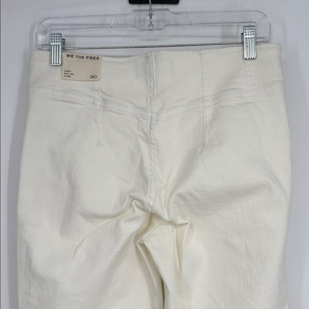 White pants on a clear hanger with 'We the Free' label.