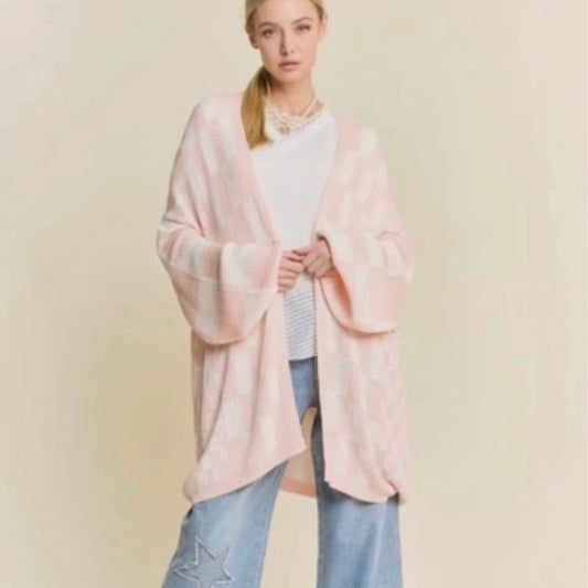 Woman wearing a pink kimono-style garment against a beige background