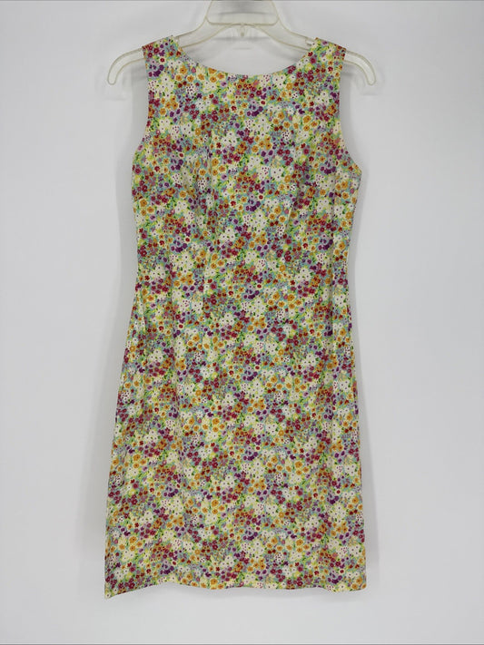 Multicolored floral dress on a white hanger against a white background