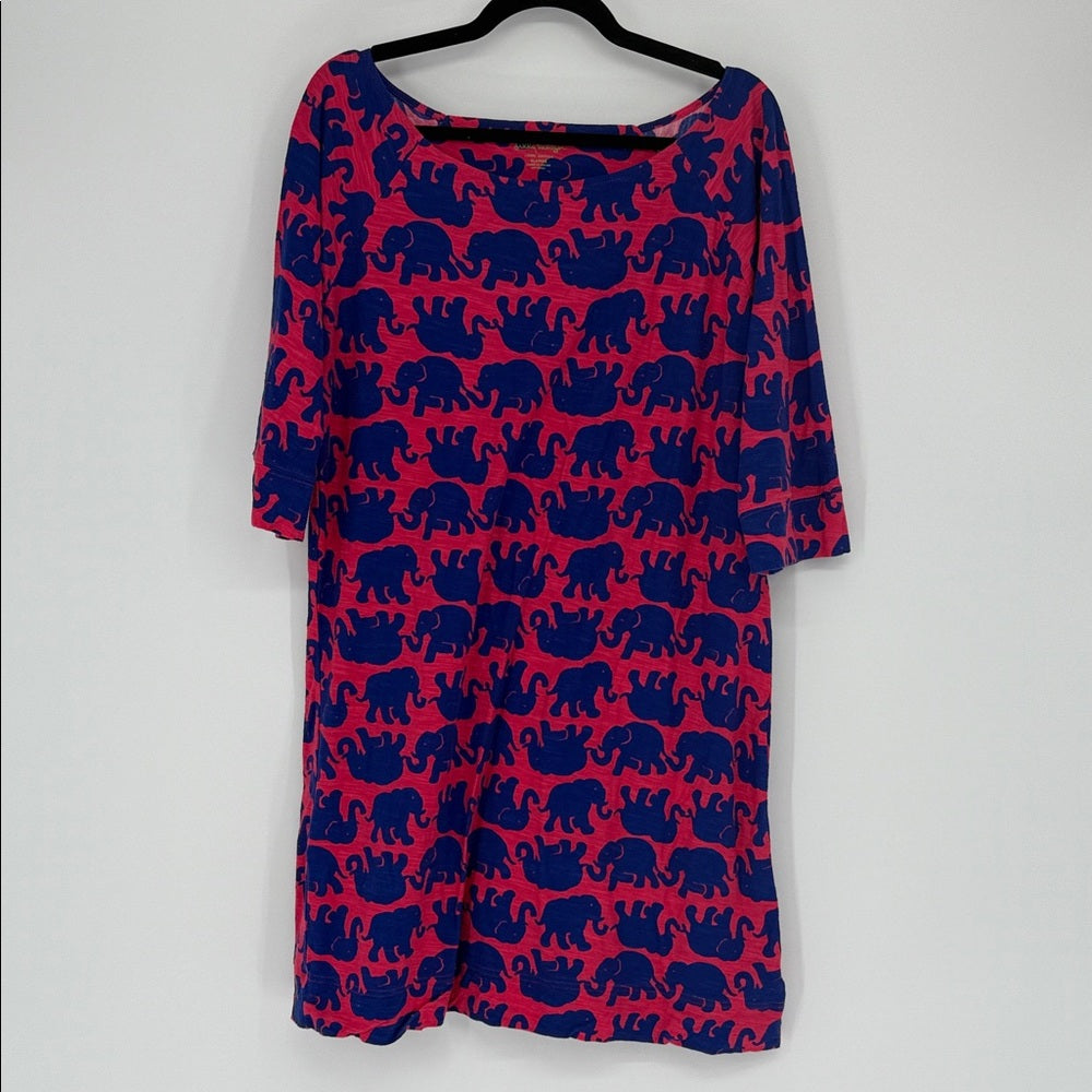 Red dress with blue elephant pattern on a hanger against a white background