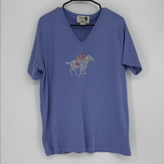 Blue t-shirt with horse and rider graphic on a hanger against a white background