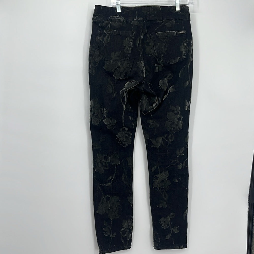 Black floral-patterned pants on a white background