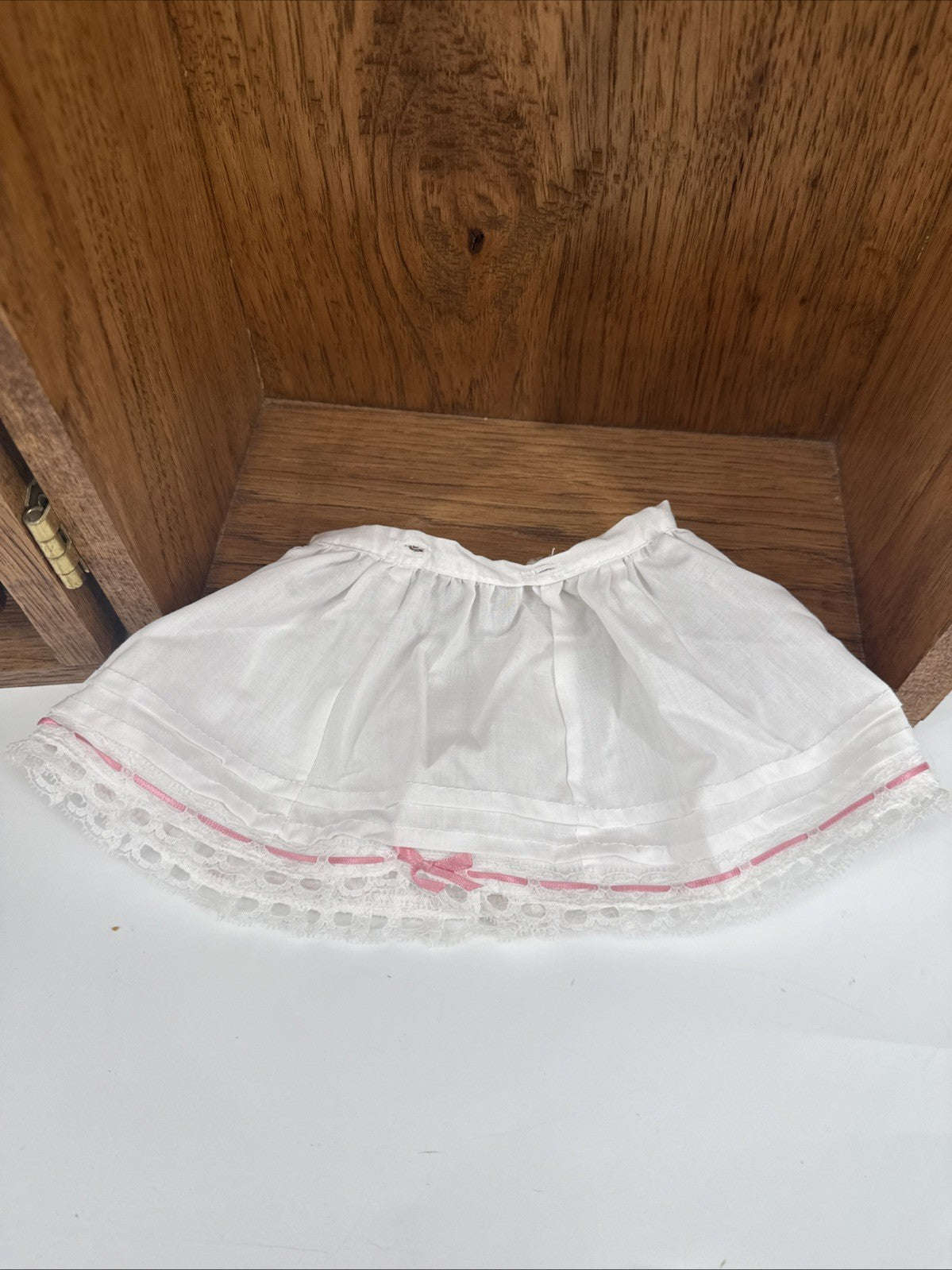 White lace collar with red trim on a white background