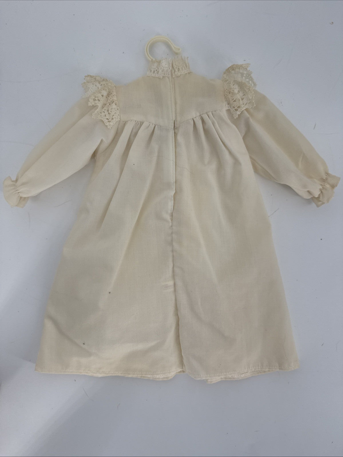 Beige dress with floral details on a white background