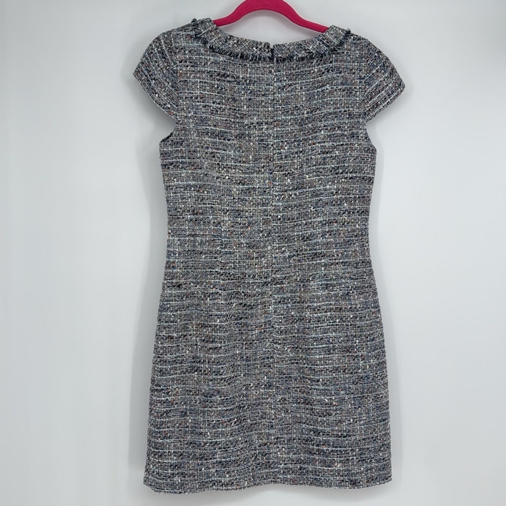 Black and white patterned dress on a hanger against a white background