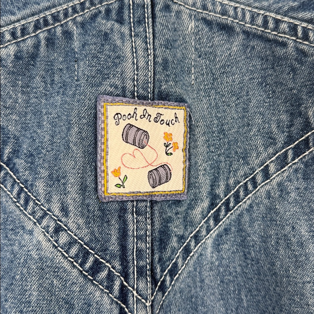 Patch on a denim jacket with 'Pooh In Touch' branding