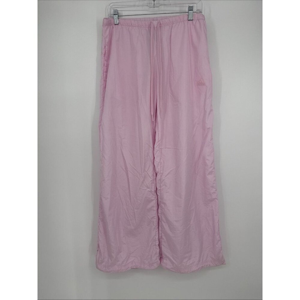 Pink pants hanging on a white wall