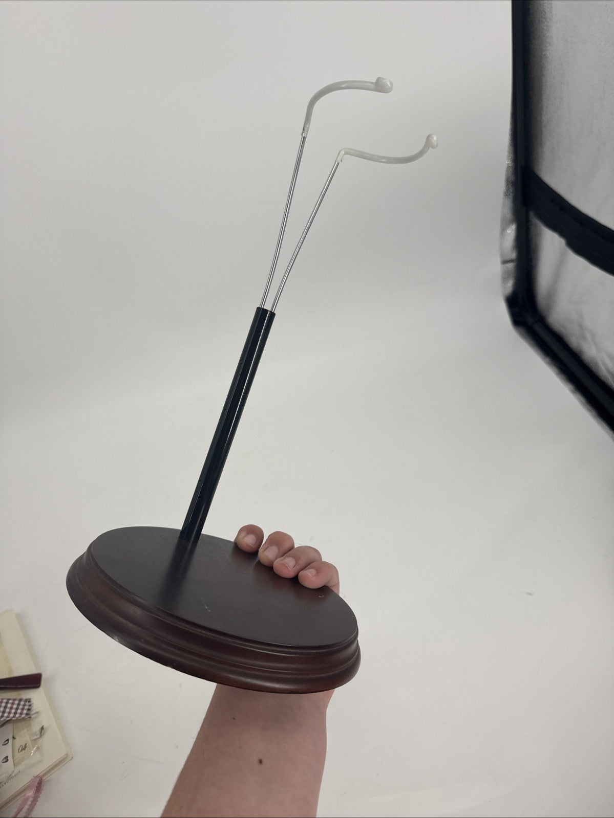 Wooden stand with a metal hook on a white background