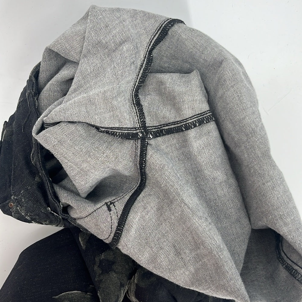 Gray denim jacket with black stitching on a white background