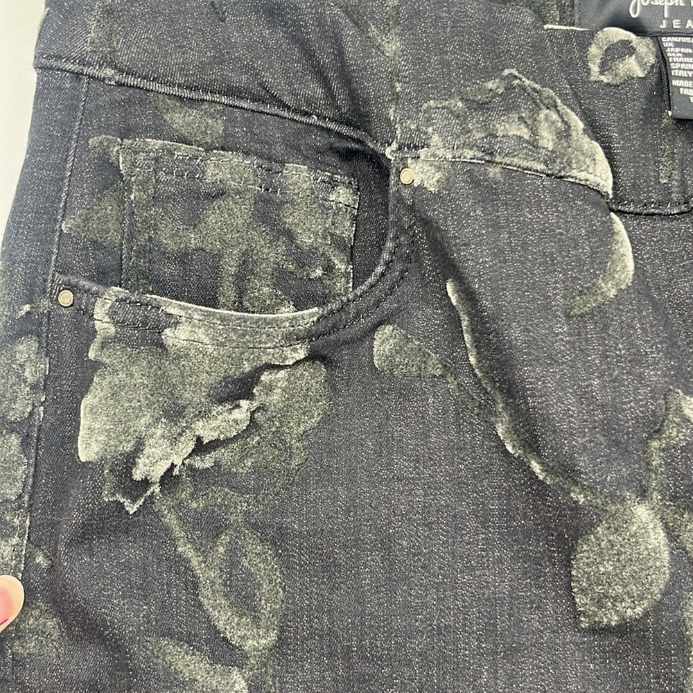 Close-up of a distressed denim jacket with visible wear and tear.