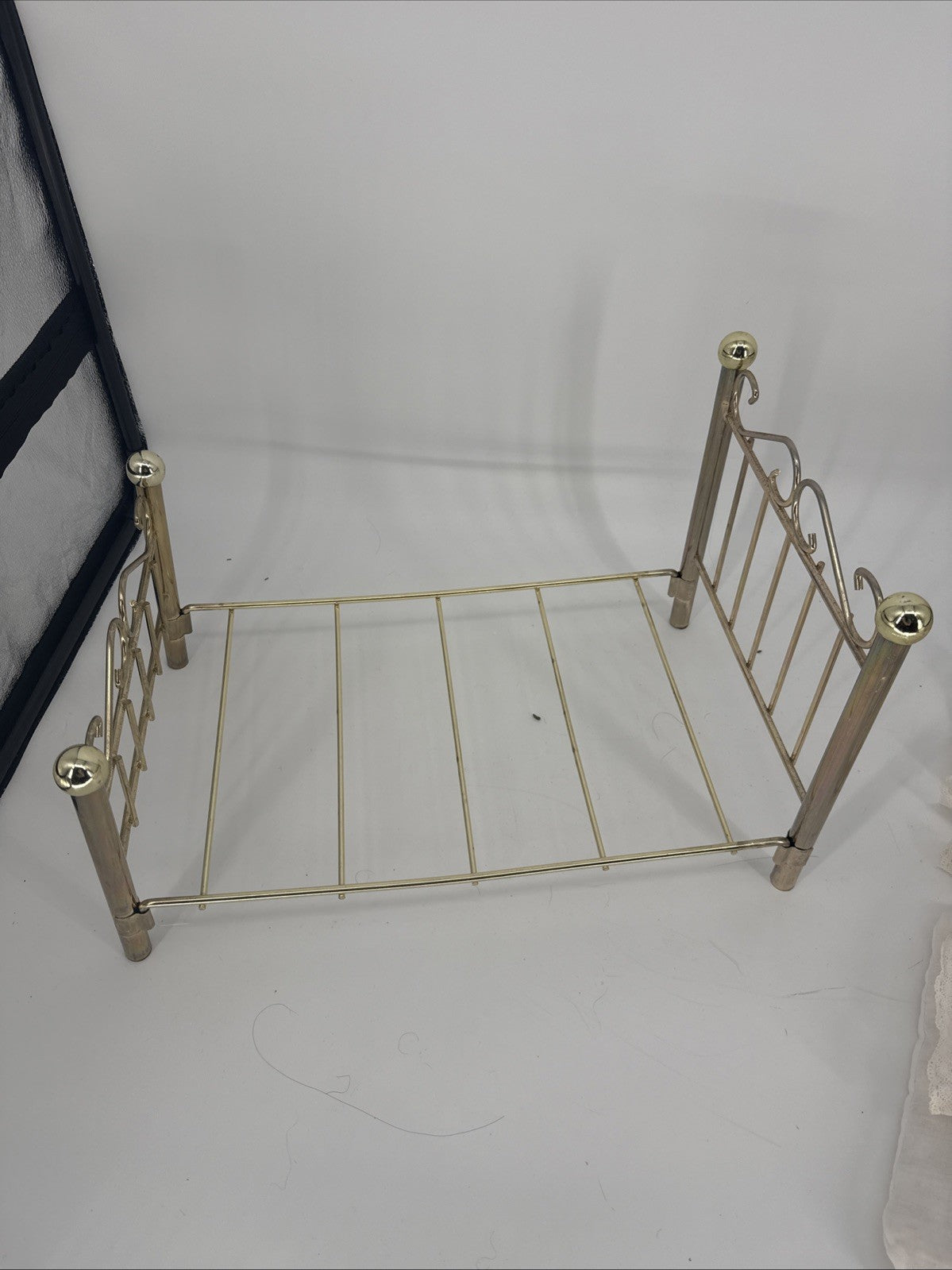 Small metal bed frame on a white background