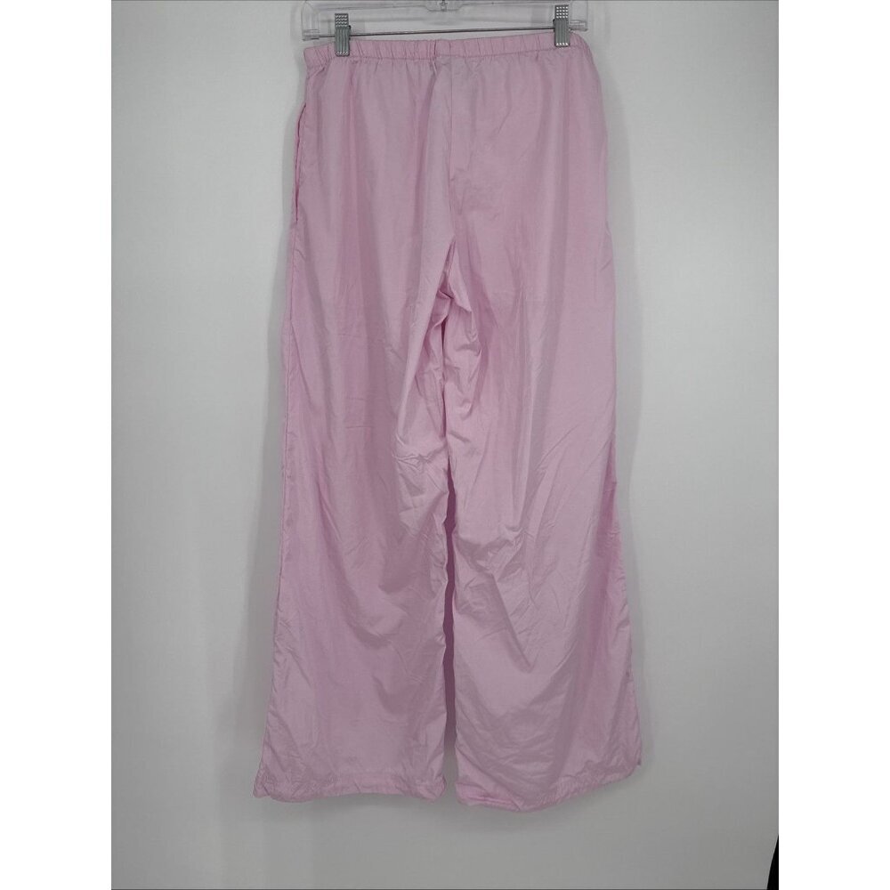 Pink pants hanging on a white wall