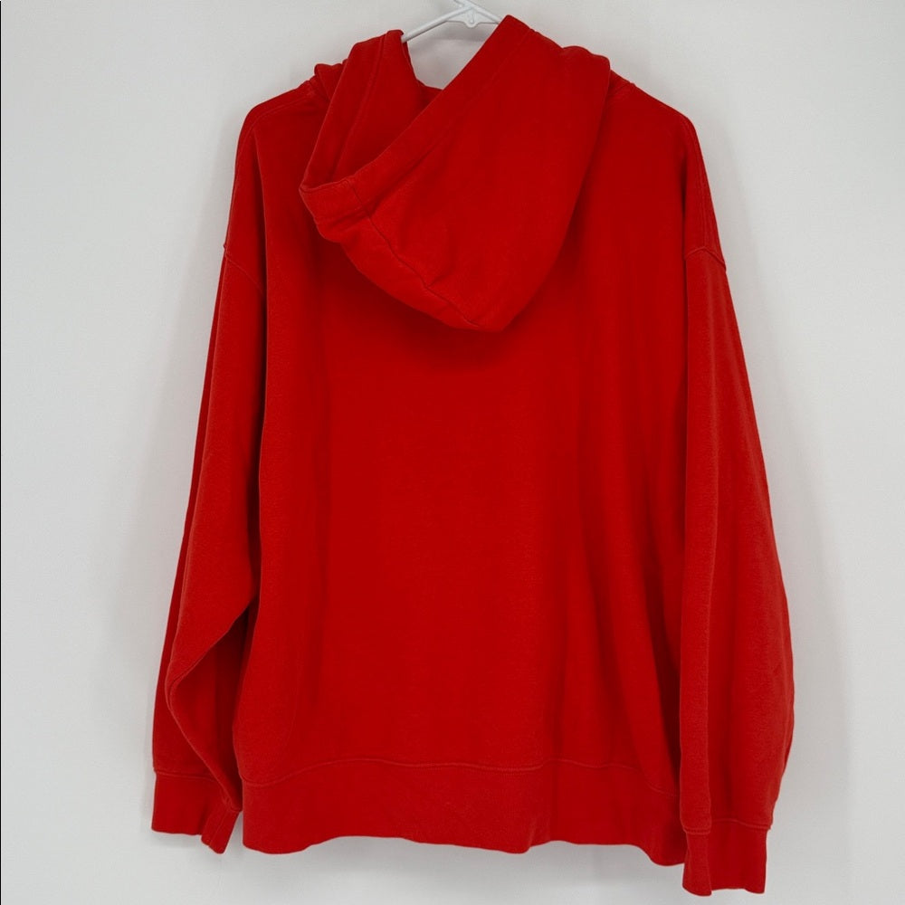 Red hoodie on a white hanger against a white background