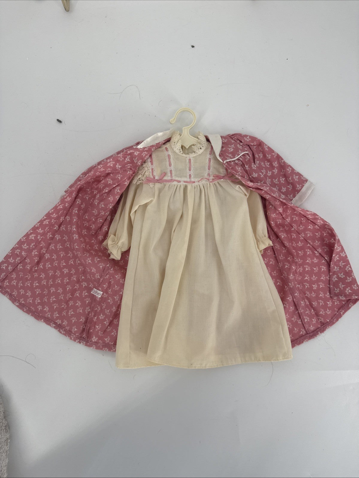 Beige dress with pink floral jacket on a white background