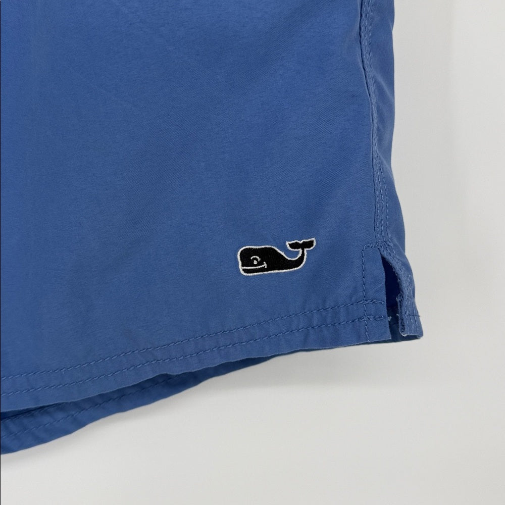Blue shorts with a whale logo on a white background