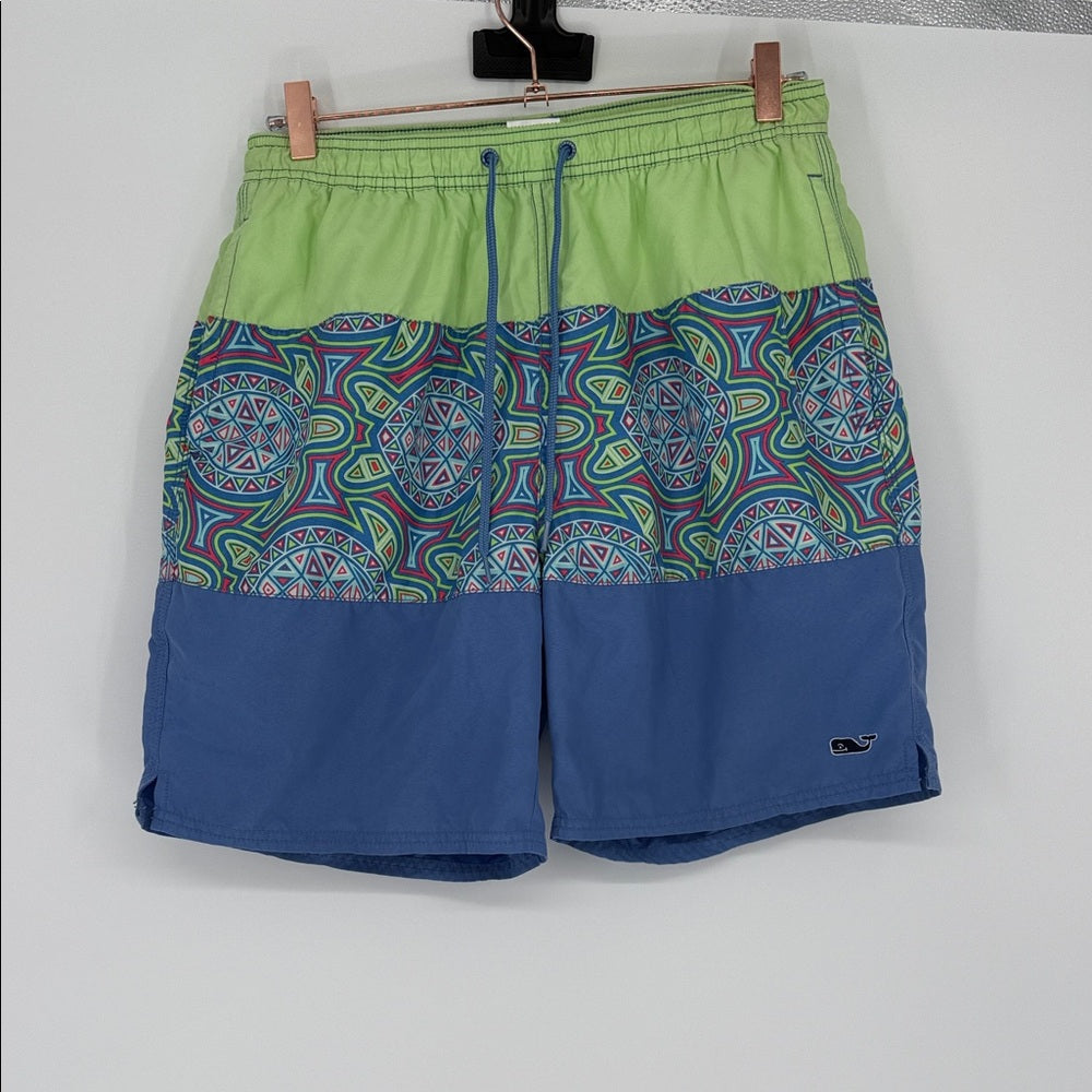 Colorful patterned shorts with green top and blue bottom on a white background