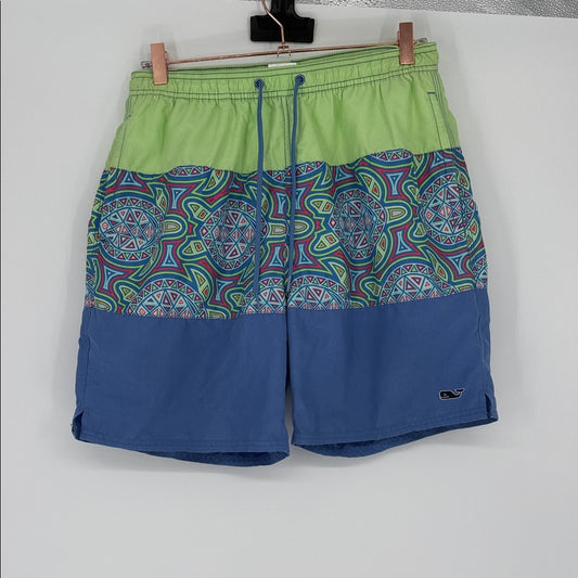 Colorful patterned shorts with green top and blue bottom on a white background