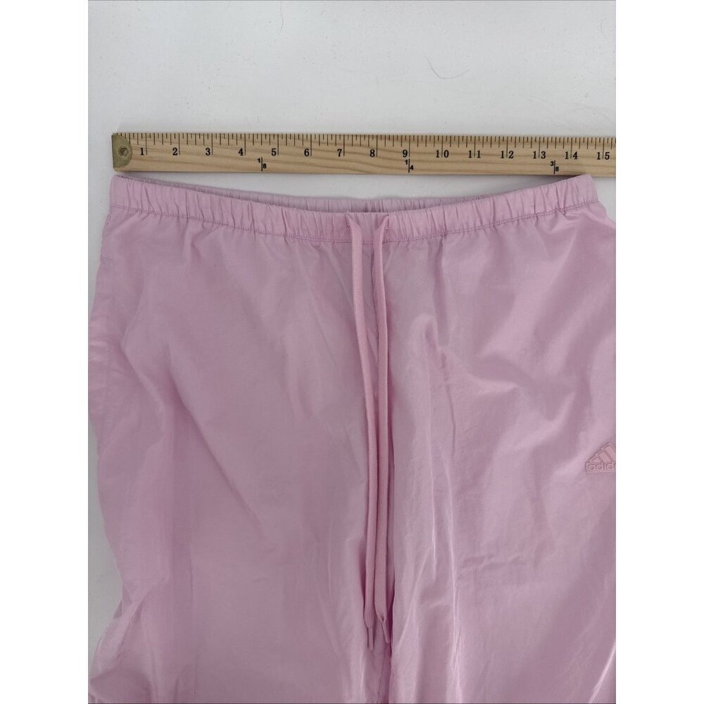 Pink pants with a ruler for size reference on a white background