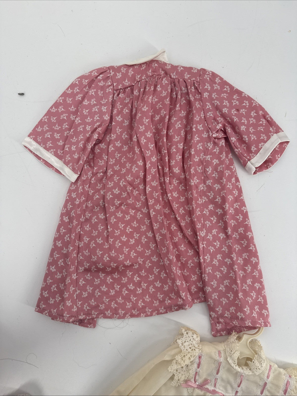 Pink floral dress on a white surface