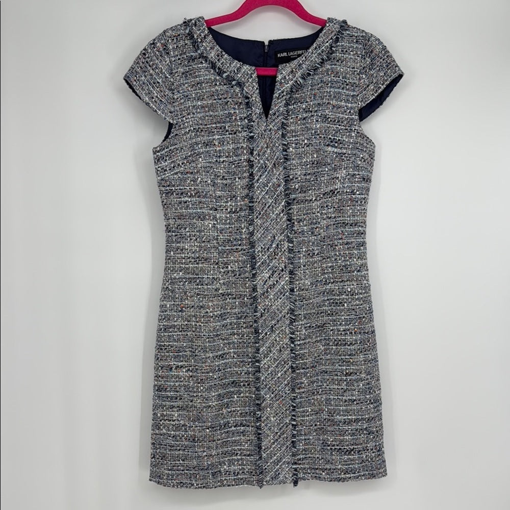 Black and gray patterned dress on a hanger against a white background