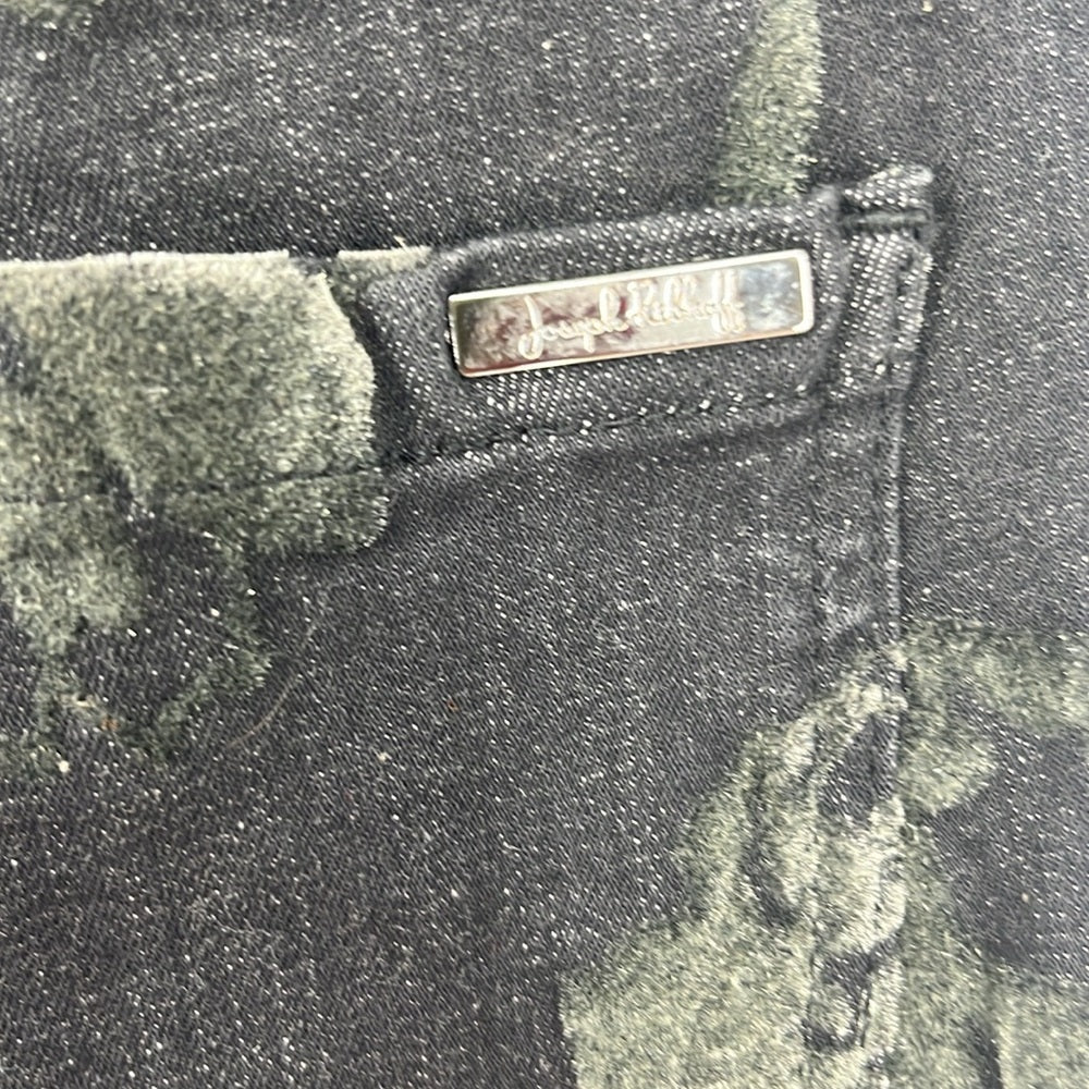 Close-up of a camouflage-patterned bag with a brand label.