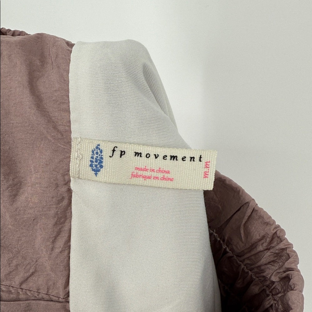 Close-up of a label on a garment with 'fp movement' branding.