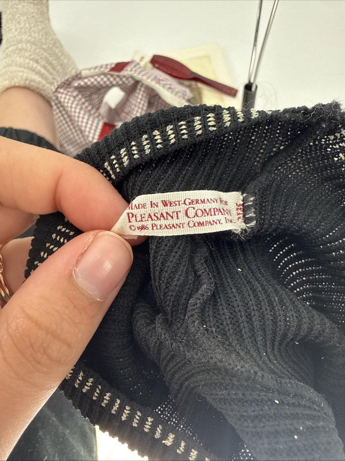 Close-up of a label on a black fabric item with a blurred background