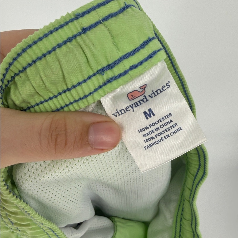 Green and white striped shirt with a Vineyard Vines label on a light gray background