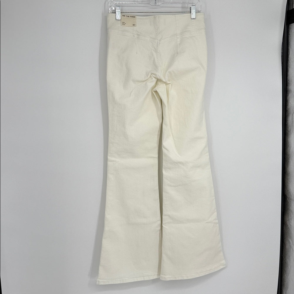 Beige pants hanging on a white background