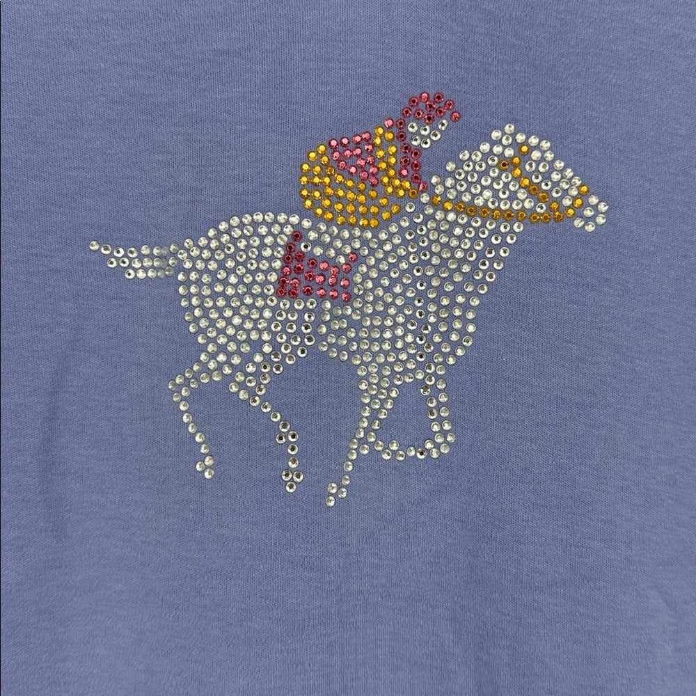 Blue shirt with a horse and jockey design made of sequins on a blue background