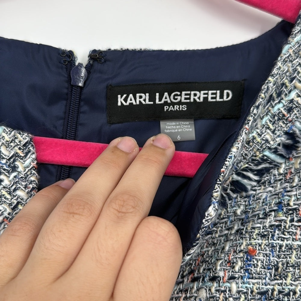 Karl Lagerfeld label on a garment with a hand pointing to it