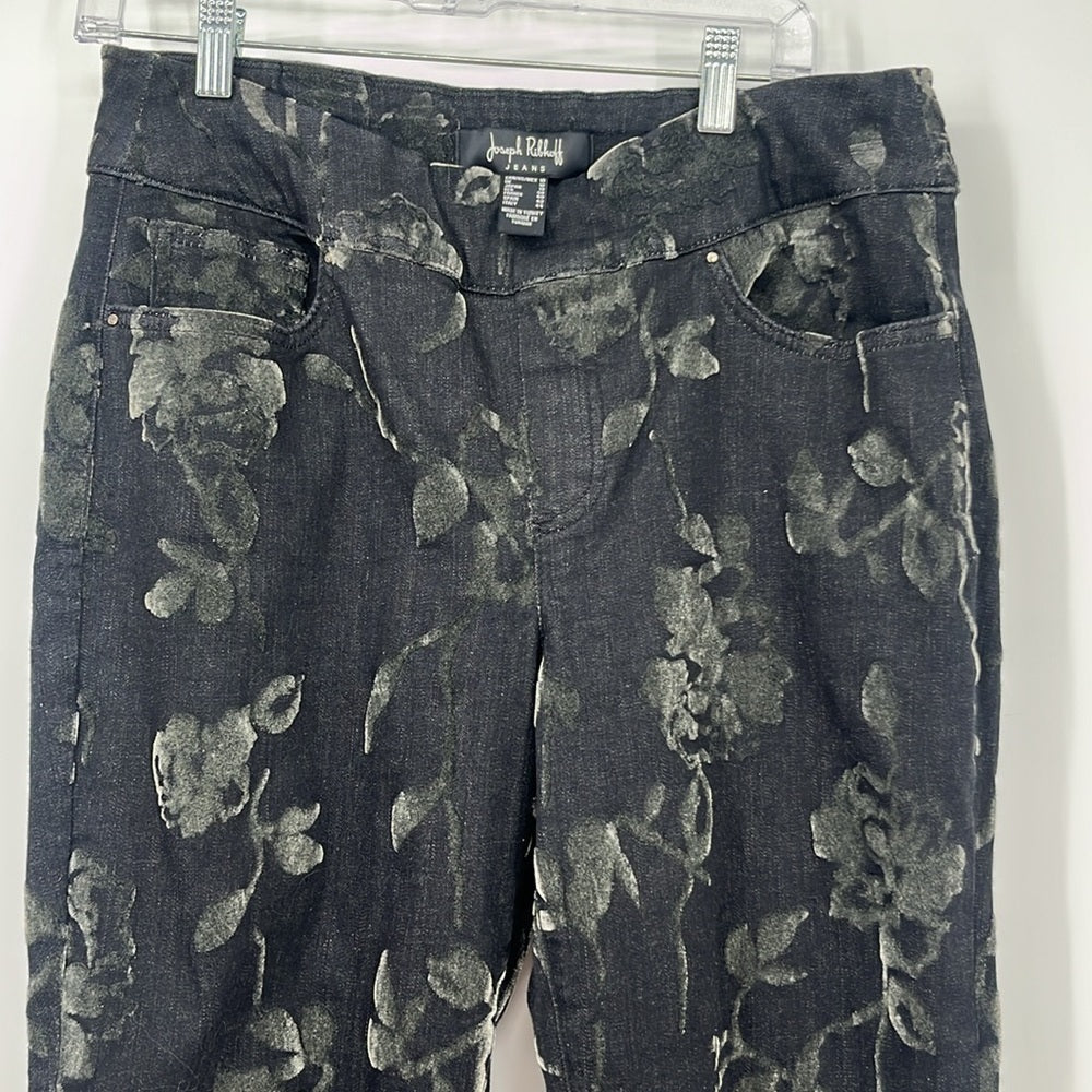 Floral-patterned jeans on a hanger against a white background